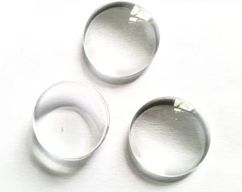 May include: Three clear glass circles, each with a smooth, reflective surface. The circles are arranged in a triangular pattern on a white background.