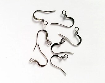 May include: Six silver-toned earring hooks with a loop at the top and a small ball at the bottom.