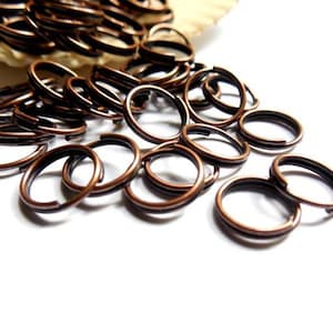 May include: A pile of copper jump rings, a type of metal ring used in jewelry making.