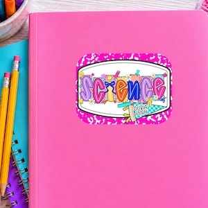 May include: A rectangular sticker with a bright pink leopard print background featuring the word SCIENCE in colorful, patterned bubble letters. The design includes small icons like pencils, flowers, and a pennant flag with the text OLIVIA LEIGH.