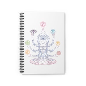 May include: A white spiral notebook with a colorful illustration of a woman in a yoga pose with seven chakras and the symbol Om.