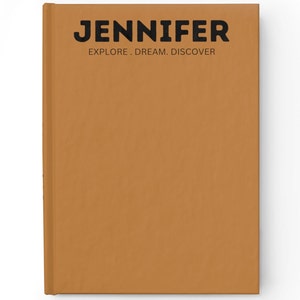 May include: A closed, hard-cover journal in a warm, earthy orange color. The cover features the name "JENNIFER" in bold, black capital letters, with the words "EXPLORE. DREAM. DISCOVER" beneath it. The journal is rectangular and appears new.