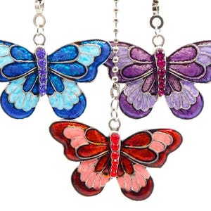 May include: Three colorful butterfly-shaped ornaments. The butterflies are in shades of blue, purple, and red, with intricate details and jewel accents. Each butterfly hangs from a silver chain, perfect for decorative use.