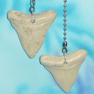 May include: Two white plastic shark tooth shaped fan pull chains with silver chains.