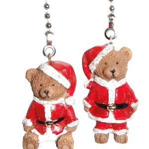 May include: Two brown teddy bear ceiling fan pulls, each wearing a red and white Santa Claus suit with a matching hat. The bears are attached to silver-colored metal ball chains. One bear is in a seated position, while the other is standing.