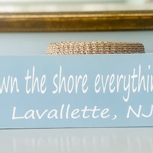 May include: Light blue wooden sign with white text that reads "'cause down the shore everything's alright" and "Lavallette, NJ".
