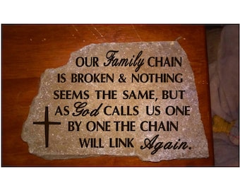 May include: A stone with a cross engraved on it and the text "OUR Family CHAIN IS BROKEN & NOTHING SEEMS THE SAME, BUT AS God CALLS US ONE BY ONE THE CHAIN WILL LINK Again."