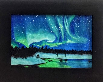 May include: A rectangular painting in a black frame depicting a night landscape with a vibrant green and blue aurora borealis stretching across a starry sky above a dark silhouette of a forest and a reflective, light-coloured snowy ground.
