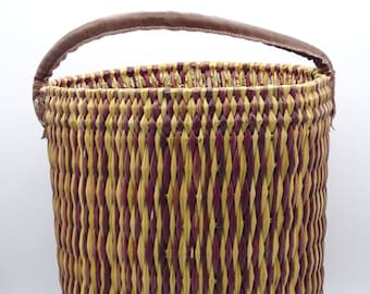 Vintage straw storage basket with a leather handle, decorative storage basket