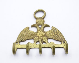 Small brass key rack adorned with a double headed eagle