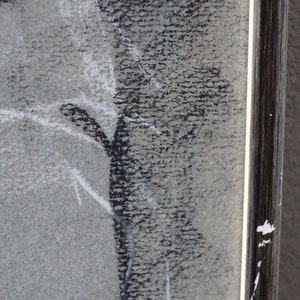 May include: A black and white charcoal drawing of a figure in a frame. The drawing is done in a loose style, with the figure's form being suggested rather than fully defined.