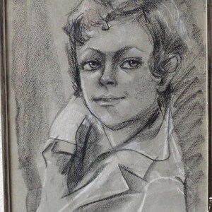 May include: Black and white charcoal drawing of a young person with short hair, wearing a collared shirt. The drawing is signed "Aurora Cec Paris 75".