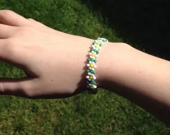 Daisy bracelet made from white and green czech glass seedbeads fastened with a silver plated lobster claw clasp.