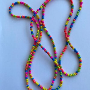Multi coloured neon beaded necklace 4mm glass beads. Boho beach hippie festival love. 56 inches long can double as a bracelet too.