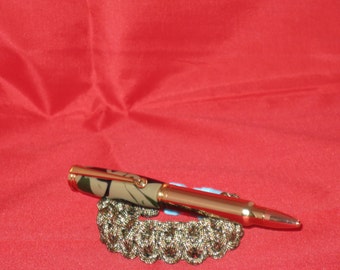 Magnum Bullet Cartridge Twist Pen( 24Kt Gold finish) includes a Camouflage Paracord bracelet as a Gift along with pen box