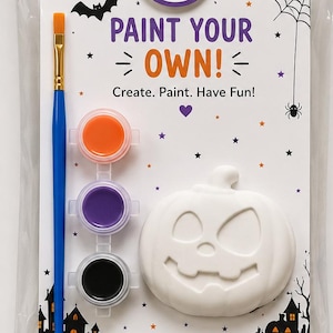 May include: A Halloween plaster paint kit featuring a white unpainted pumpkin mold, a blue-handled paintbrush, and three small paint pots in orange, purple, and black. The kit includes a card with the text Paint Your Own and a Thank You note.