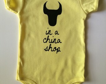 Bull In A China Shop, size: 6-12 months, Durham Baby one-piece, romper -American Apparel, Yellow with Black print