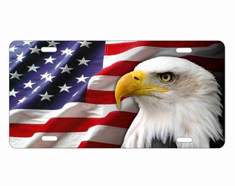 May include: A close-up of a bald eagle with a yellow beak and white feathers, looking to the right. The eagle is in front of a waving American flag with red and white stripes and blue stars.