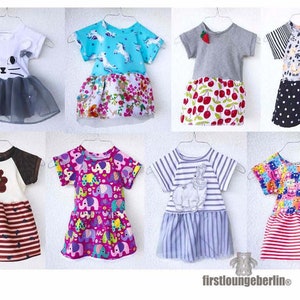 May include: A collection of eight children's dresses featuring a variety of patterns and colours. The dresses are all made from cotton and have a two-tiered skirt. The patterns include unicorns, cherries, elephants, cats, bears, and stripes.