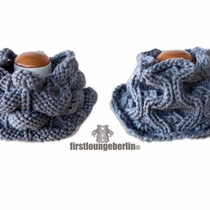 May include: Grey knitted cowl neck scarf with a textured pattern. The scarf is shown folded in half and laid flat.