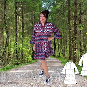 May include: A woman wearing a colorful chevron patterned dress with long sleeves and a ruffled hem. The dress has a button-up front and a high neckline. The woman is standing on a path in a forest. Two line drawings of the dress are shown on the path.