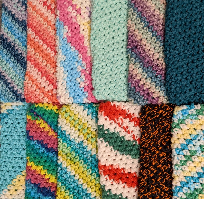 May include: A collection of colorful crocheted dishcloths in various patterns and colors, including blue, green, red, pink, and yellow.
