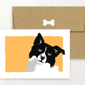 May include: A greeting card featuring a black and white illustration of a border collie dog with blue eyes, looking to the side, against a yellow background.