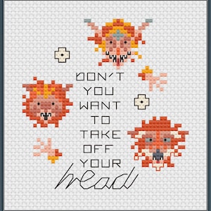 May include: Cross-stitch art with a dark blue frame. The artwork features pixelated cartoon faces in orange, yellow, and pink, along with the text "DON'T YOU WANT TO TAKE OFF YOUR head" in black. The background is white.