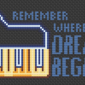 Puede incluir: Un diseño de punto de cruz con un piano amarillo con teclas negras y el texto "Remember where dreams begin" en azul.