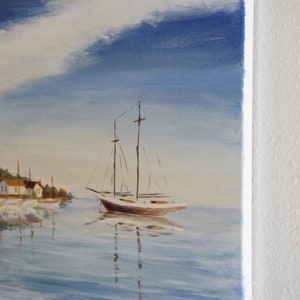May include: A painting depicting a sailboat on a tranquil body of water, with a small village visible in the background. The sky is blue with white clouds. The painting is signed "Gibson" in the bottom right corner.