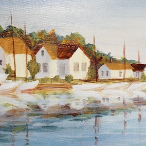 May include: A painting depicting a waterfront scene with white houses and sailboats in a harbour. The houses have brown roofs and are lined up along the water's edge. The sailboats are docked in the water, and their reflections are visible in the water.