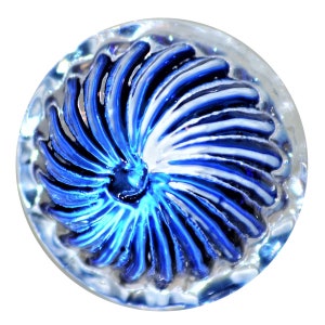 May include: A clear, round glass button with a spiral design in shades of blue and white. The button's center is a deep blue, transitioning to lighter shades and white towards the edges. The button has a textured, scalloped edge.