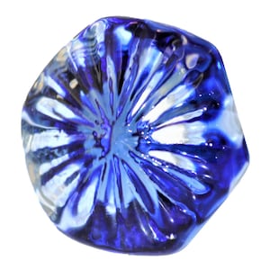 May include: A round, glass object with a vibrant blue and white color scheme. The object has a radial pattern, with the blue hues dominating the outer edges and transitioning to white in the center. The glass appears glossy and reflective.