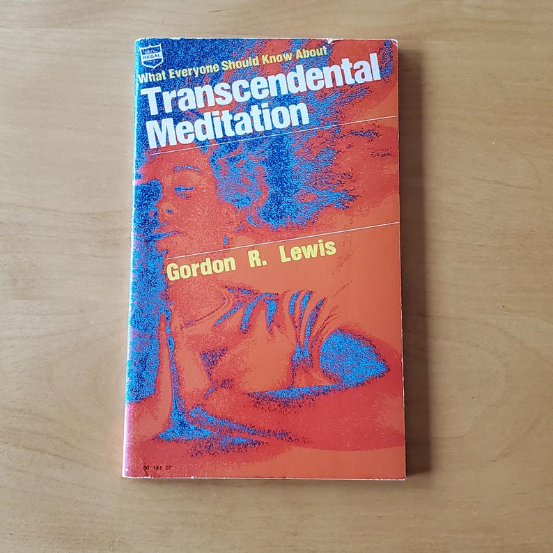 May include: A vintage paperback book titled "What Everyone Should Know About Transcendental Meditation" by Gordon R. Lewis. The cover features a person's silhouette in blue against an orange background.
