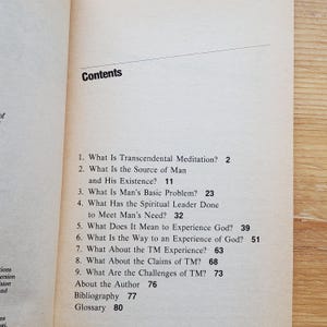 May include: Open book page with the title "Contents" at the top. The table of contents lists chapter titles such as "What Is Transcendental Meditation?" and "What Is the Source of Man and His Existence?" in black text.