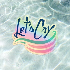 Peut inclure: Un autocollant avec le texte "Let's Cry" en bleu sur un fond arc-en-ciel. L'autocollant flotte dans une piscine.