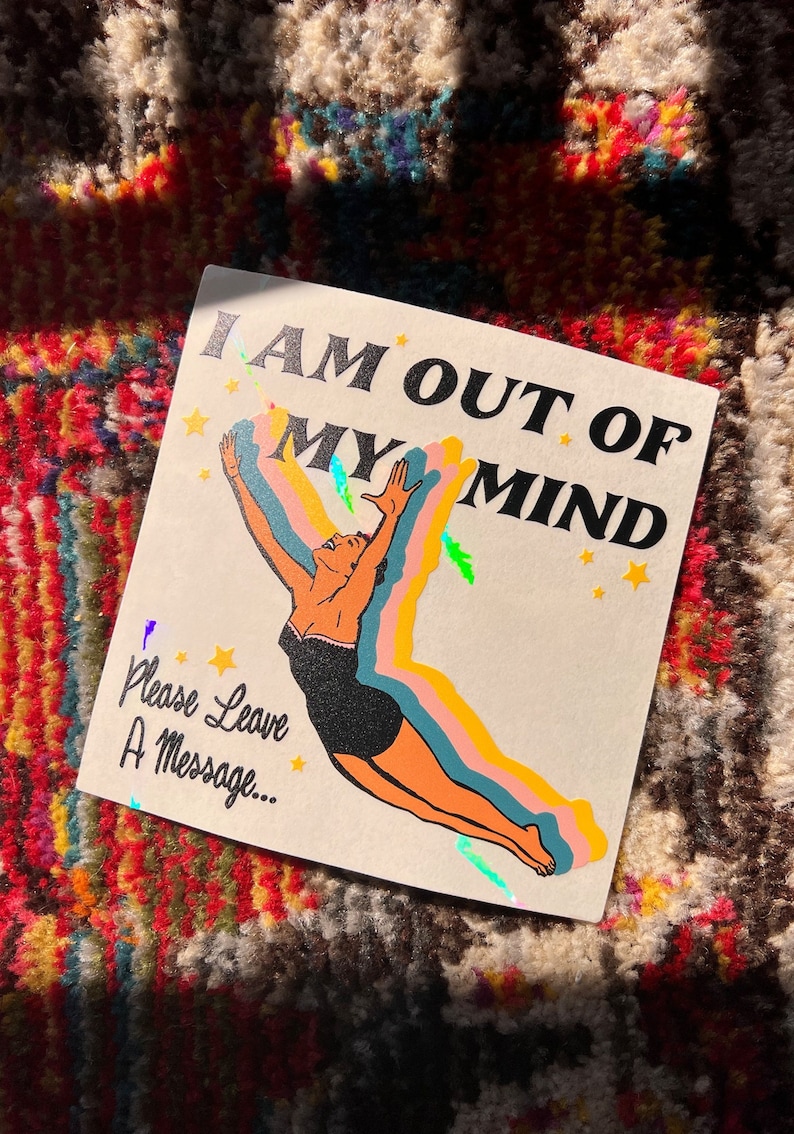 May include: A white card with a retro illustration of a woman diving into a rainbow. The text reads "I am out of my mind. Please leave a message..."