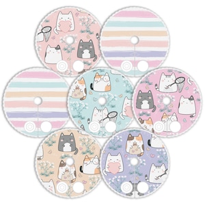 May include: Seven round stickers with a white border and a variety of cute cat designs. The stickers feature cats with different expressions, holding hearts, butterflies, and nets. The backgrounds are pastel pink, blue, and green with floral patterns and stripes.