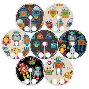 May include: Seven circular fabric items with robot designs in various colors. Each robot has a unique design, with details like hearts, gears, and the word "Beep". The backgrounds vary from black to cream.