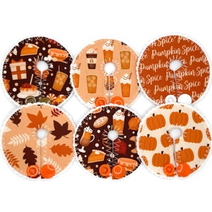 May include: Six round fabric patches with different fall-themed designs. The designs include pumpkins, leaves, coffee cups, and the text "Pumpkin Spice".