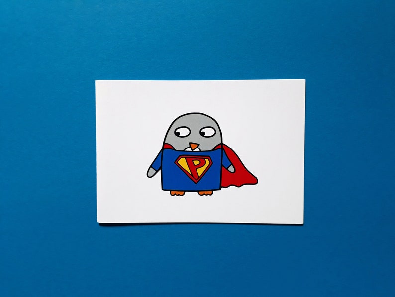 May include: A cartoon illustration of a gray penguin dressed as a superhero. The penguin wears a blue suit with a yellow and red emblem and a red cape. The background is a solid blue.