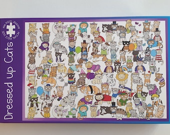 May include: A jigsaw puzzle box with a purple border and the words "Dressed up Cats." The puzzle features numerous cartoon cats in various costumes and outfits. The puzzle is labeled as 1000 pieces.
