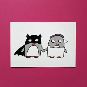 May include: A charming illustration featuring two penguins. One is dressed as a superhero with a black mask and cape, the other as a bride with a floral crown and veil. They are holding hands. Set against a bright pink background.