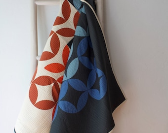 Modern quilted wall hanging, orange peel design, black, cream, red and blue