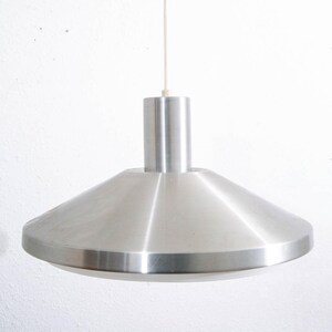 May include: A silver pendant light with a wide, flat, circular shade and a cylindrical stem.