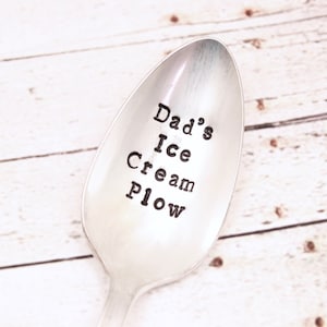 May include: A silver spoon with the words "Dad's Ice Cream Plow" engraved on it.