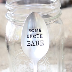 May include: A silver spoon with the words "Bone Broth Babe" engraved on it.