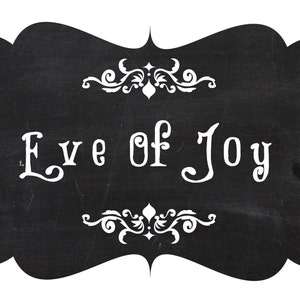 May include: Black chalkboard sign with white decorative flourishes and the text "Eve of Joy" written in a stylized font.