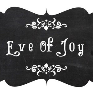 May include: Black chalkboard sign with white decorative flourishes and the text "Eve of Joy" written in white.