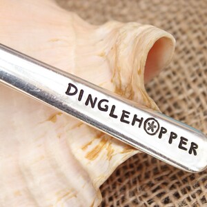 May include: A silver spoon with the words "Dinglehopper" and a starfish engraved on the handle.